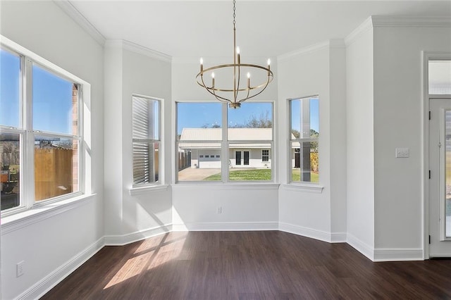 unfurnished dining area featuring a notable chandelier, wood finished floors, baseboards, and ornamental molding