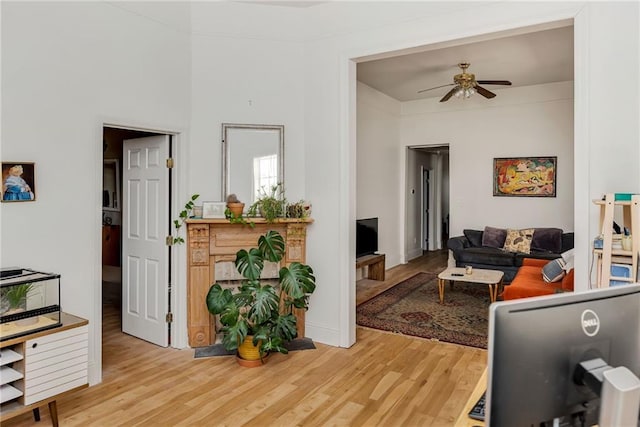 living area featuring wood finished floors and a ceiling fan