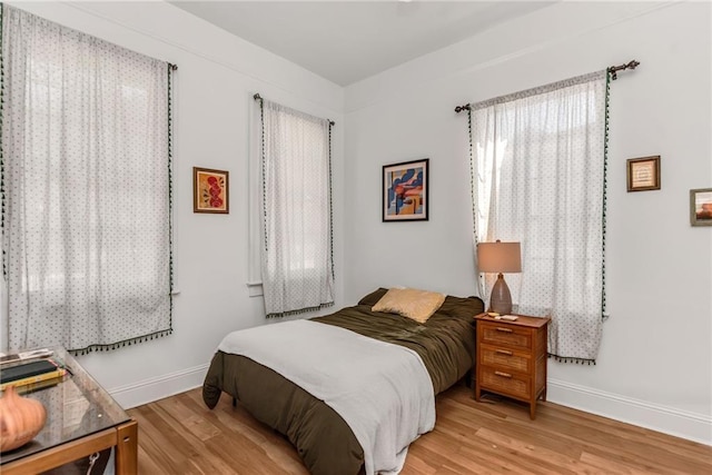 bedroom with baseboards and light wood-style floors