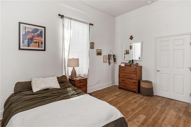 bedroom featuring baseboards and light wood-type flooring