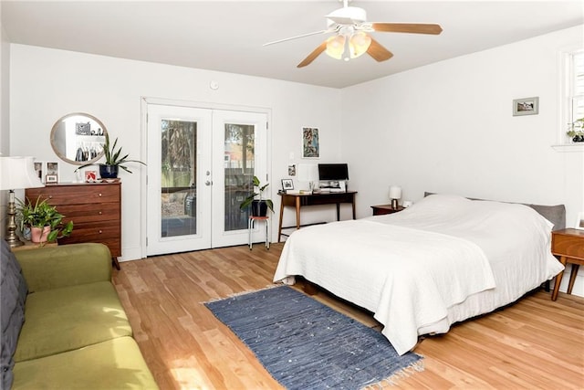 bedroom with access to exterior, wood finished floors, french doors, and ceiling fan