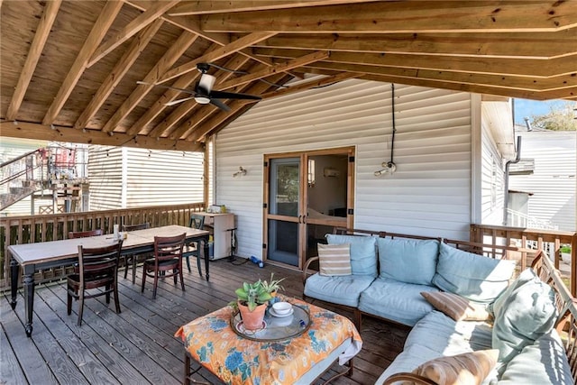 deck with outdoor dining space, ceiling fan, and an outdoor hangout area