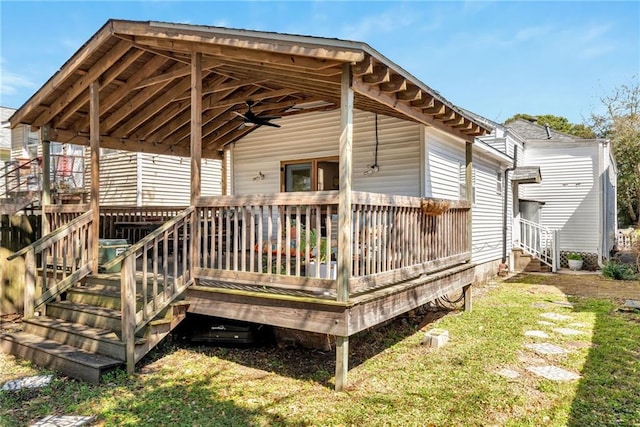 deck featuring a lawn and ceiling fan