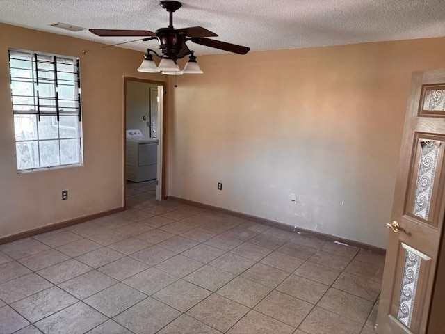 unfurnished room with baseboards, washer / clothes dryer, ceiling fan, and light tile patterned flooring