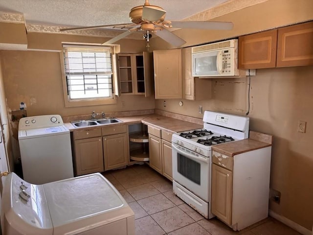 kitchen with a sink, washer / clothes dryer, white appliances, and a ceiling fan