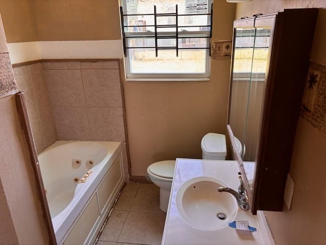 bathroom featuring tile patterned floors, toilet, vanity, and a whirlpool tub