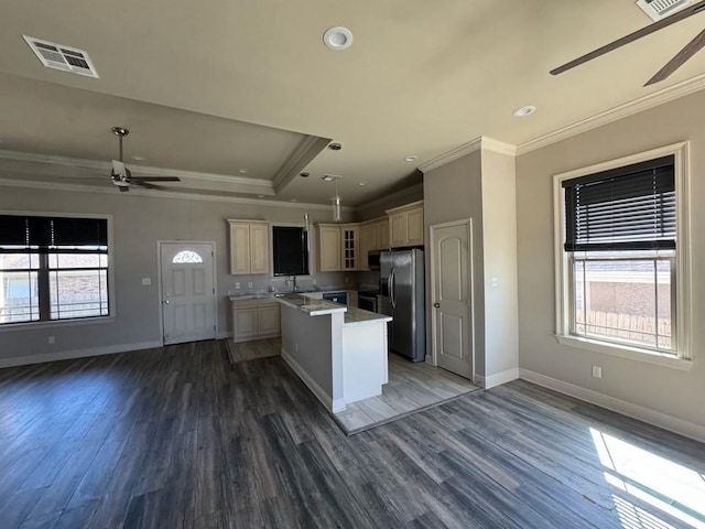 kitchen featuring stainless steel fridge, plenty of natural light, open floor plan, and a ceiling fan