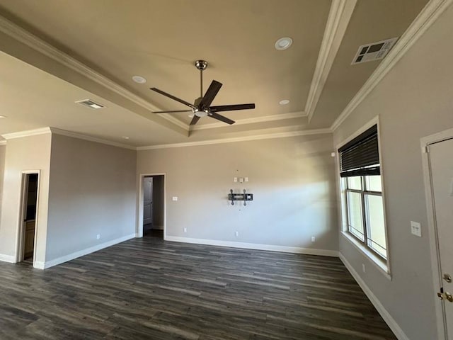 empty room featuring a tray ceiling, baseboards, visible vents, and a ceiling fan