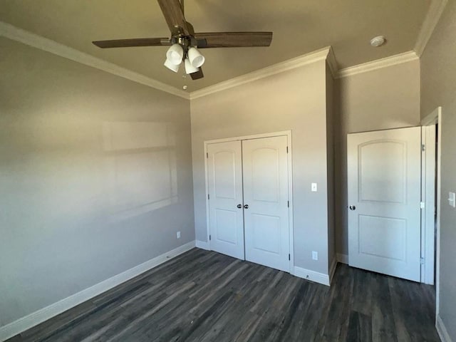 unfurnished bedroom with crown molding, baseboards, and dark wood-style flooring