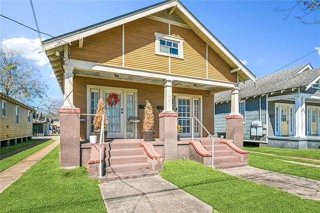 view of front of home with covered porch and a front yard