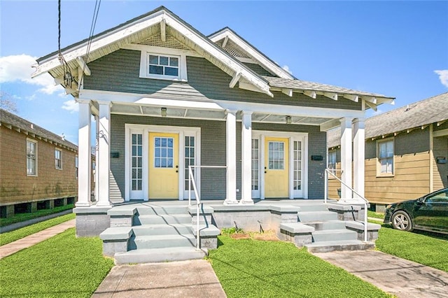 view of front of house featuring a porch and a front yard