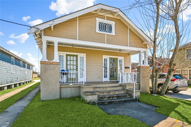 view of front of house with a front lawn and covered porch