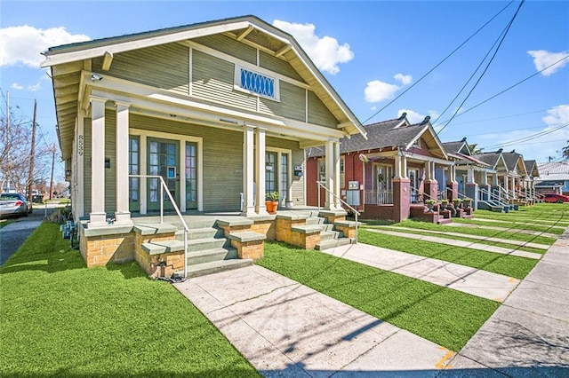 view of front of home with a porch and a front yard