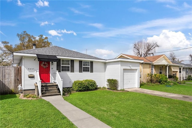 view of front of house with a garage, concrete driveway, a front yard, and fence