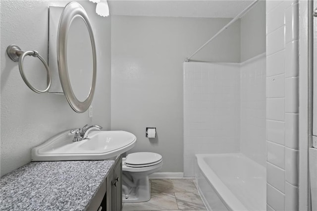 bathroom featuring baseboards, toilet, bathtub / shower combination, marble finish floor, and vanity