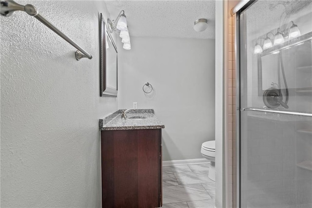 bathroom featuring a shower stall, toilet, marble finish floor, a textured ceiling, and vanity