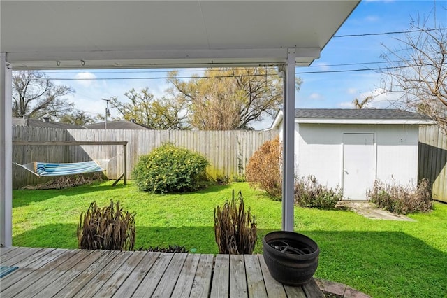 view of yard with a shed, an outdoor structure, and fence