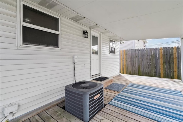 deck featuring central air condition unit and fence