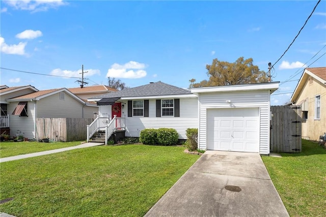 view of front of home with a front yard, concrete driveway, fence, and a garage