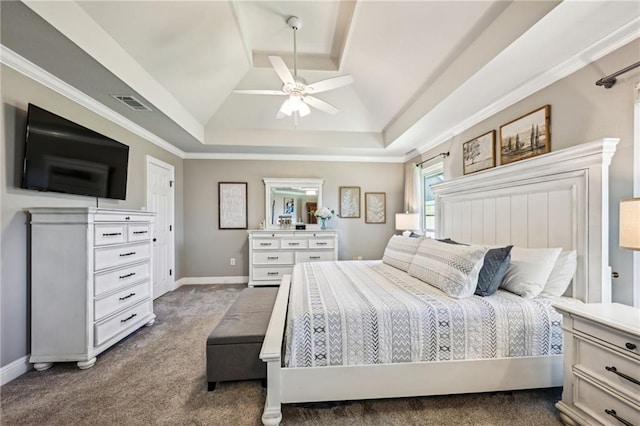 bedroom featuring visible vents, a ceiling fan, a tray ceiling, dark colored carpet, and baseboards