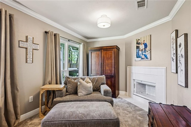 sitting room with visible vents, carpet, a fireplace, crown molding, and baseboards