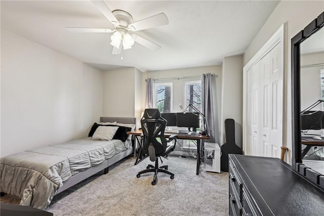 bedroom with a closet, carpet floors, and ceiling fan