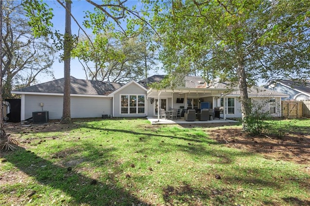 back of property featuring fence, central AC unit, a lawn, and a patio area