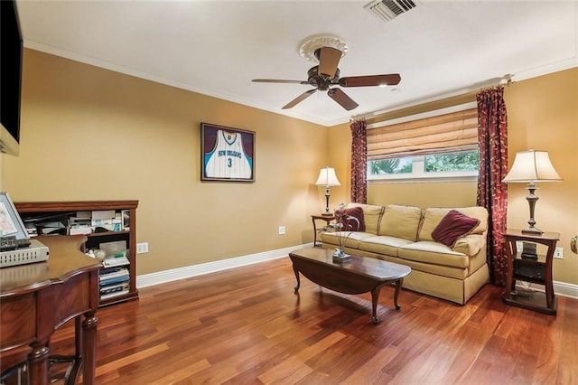 living area with visible vents, crown molding, a ceiling fan, and wood finished floors