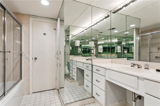 full bath featuring visible vents, bath / shower combo with glass door, vanity, and tile patterned flooring