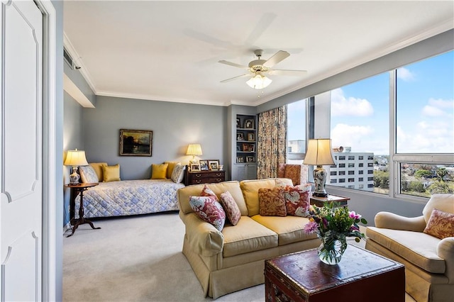 carpeted bedroom featuring a ceiling fan and crown molding