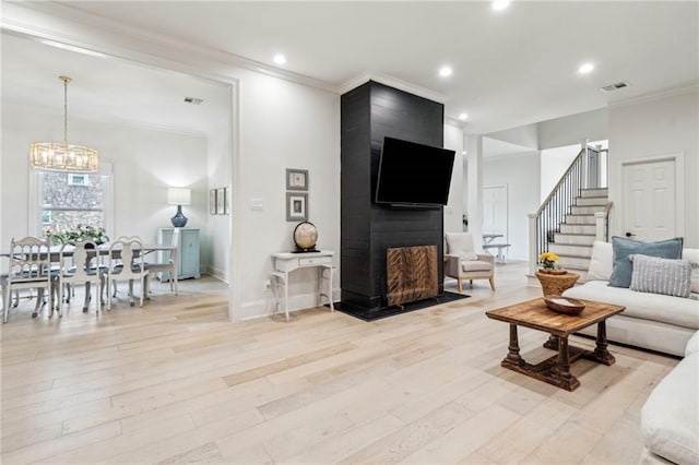 4533 N Turnbull Dr, Metairie, LA 70002 - living area with an inviting chandelier, crown molding, visible vents, and light wood finished floors