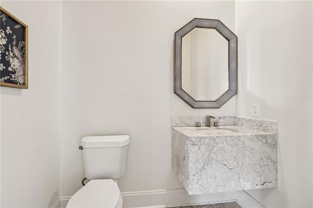 4533 N Turnbull Dr, Metairie, LA 70002 - half bath with toilet, baseboards, and a sink