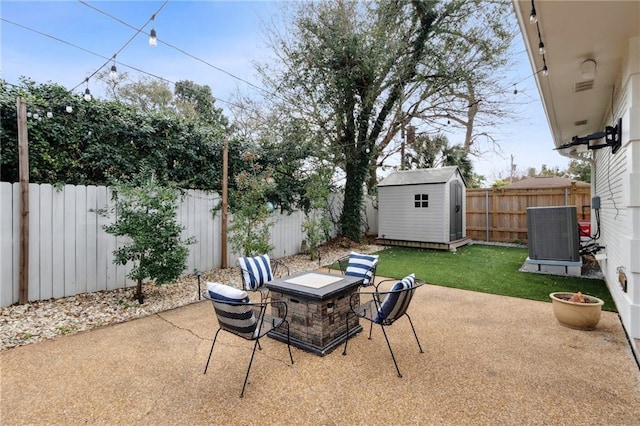 4533 N Turnbull Dr, Metairie, LA 70002 - view of patio featuring an outdoor fire pit, cooling unit, a storage shed, a fenced backyard, and an outbuilding