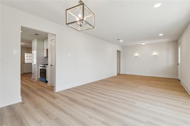 spare room featuring visible vents, recessed lighting, light wood-type flooring, and baseboards