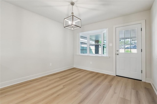 interior space with light wood finished floors and baseboards