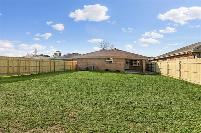 view of yard featuring central air condition unit and a fenced backyard