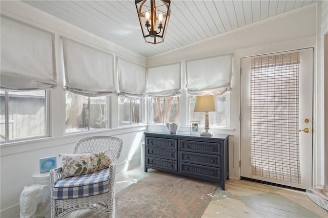 sunroom featuring a chandelier, wood ceiling, and lofted ceiling