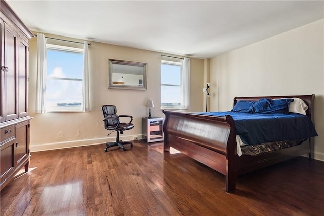 bedroom featuring dark wood finished floors and baseboards