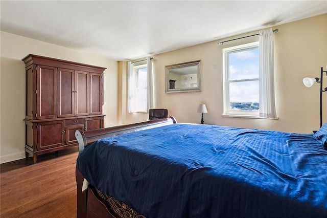 bedroom featuring dark wood-type flooring and baseboards