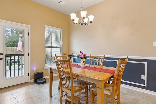 dining space featuring a chandelier, visible vents, baseboards, and light tile patterned flooring