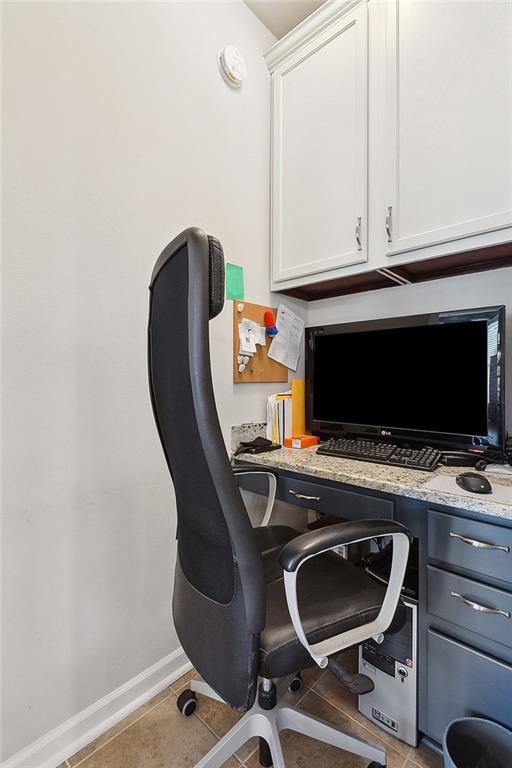 office with tile patterned flooring and baseboards