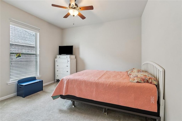 carpeted bedroom featuring ceiling fan and baseboards