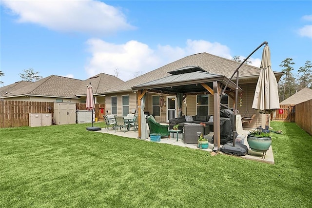 rear view of house with a patio, a fenced backyard, a gazebo, a lawn, and an outdoor hangout area