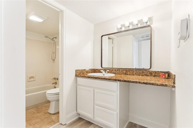 full bathroom featuring vanity, washtub / shower combination, baseboards, tile patterned floors, and toilet