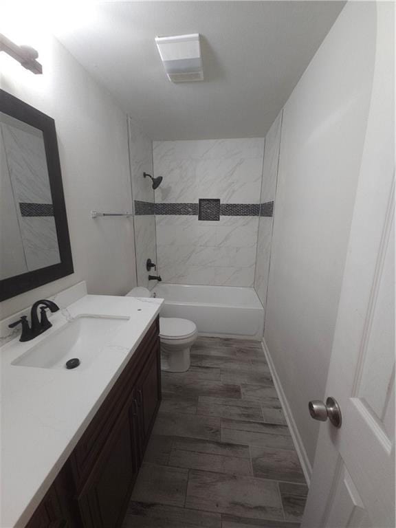 full bathroom with shower / bath combination, toilet, vanity, and baseboards