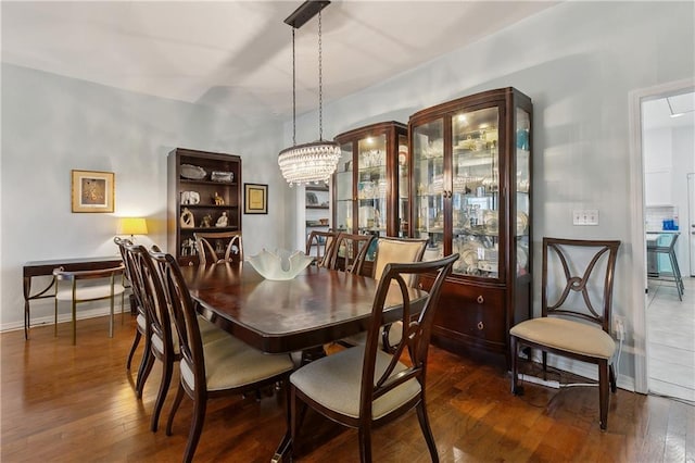 dining room with baseboards and hardwood / wood-style floors