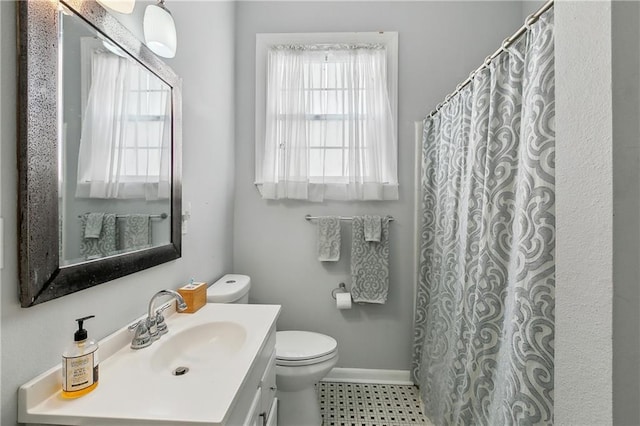 bathroom featuring vanity, curtained shower, toilet, and baseboards