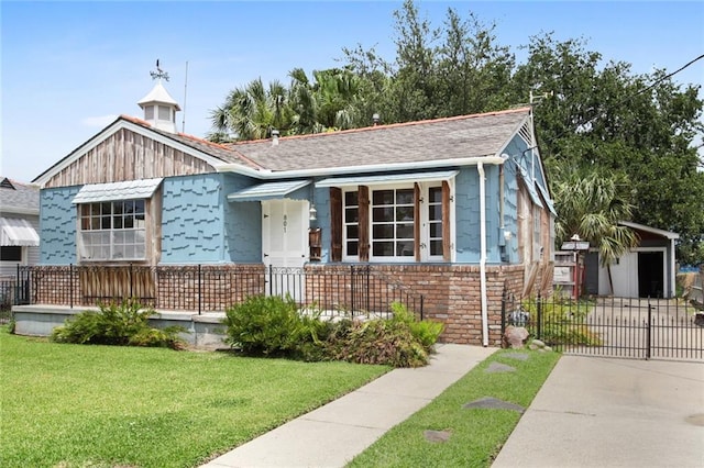 bungalow-style house with a front lawn, fence, and driveway