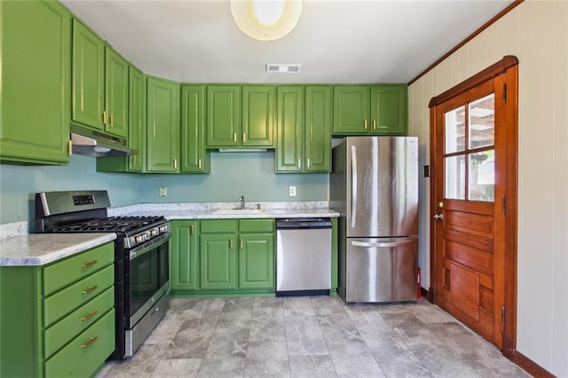 kitchen featuring under cabinet range hood, light countertops, appliances with stainless steel finishes, and green cabinetry