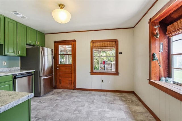 kitchen with baseboards, visible vents, stainless steel appliances, green cabinets, and crown molding